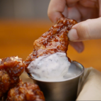 hoots wings franchise wing dipped in sauce